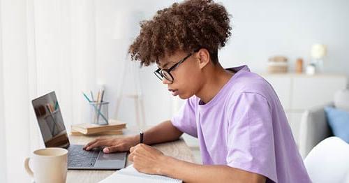 An online school student studying for mid-term exams